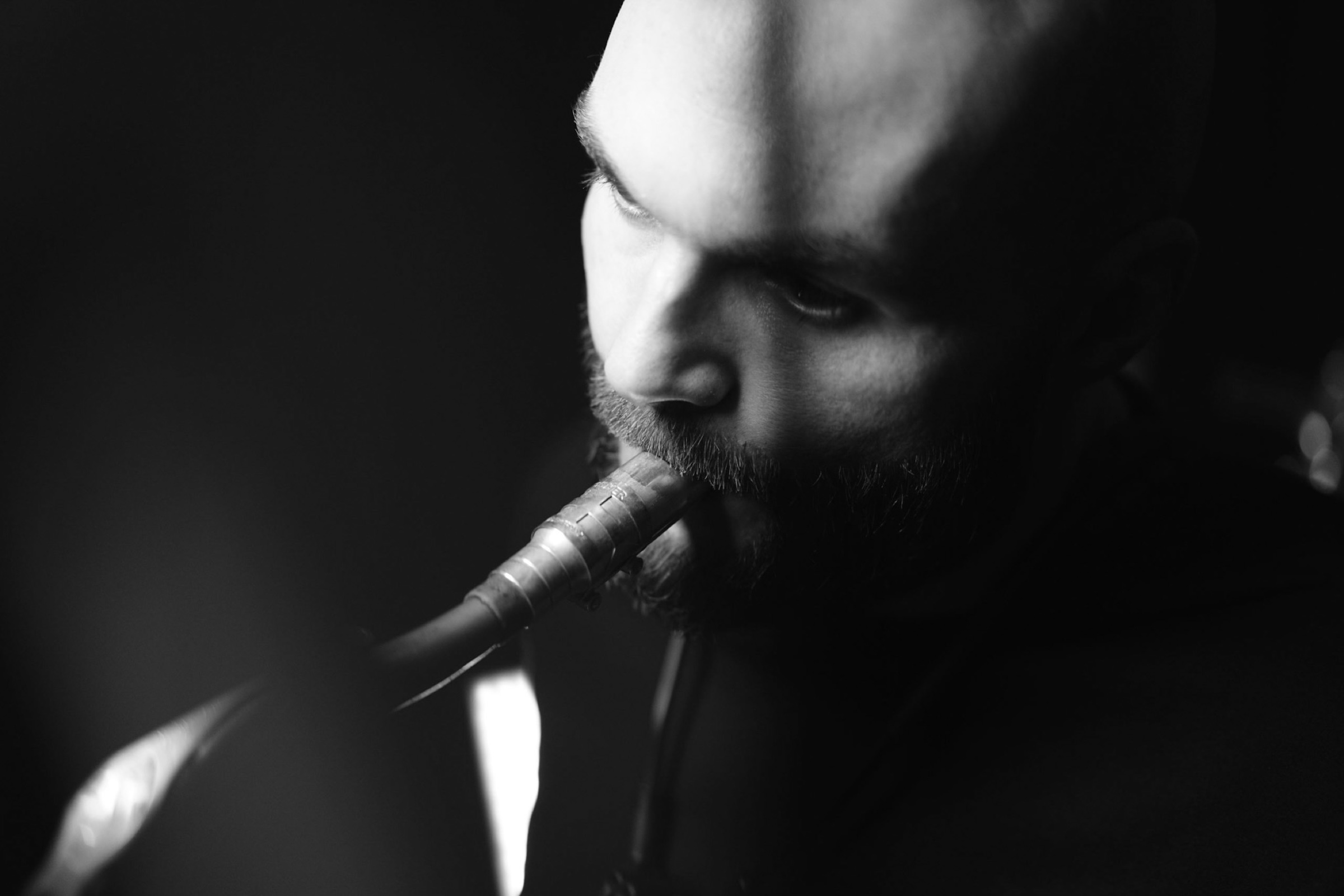 Black-and-white detail portrait of a saxophone player