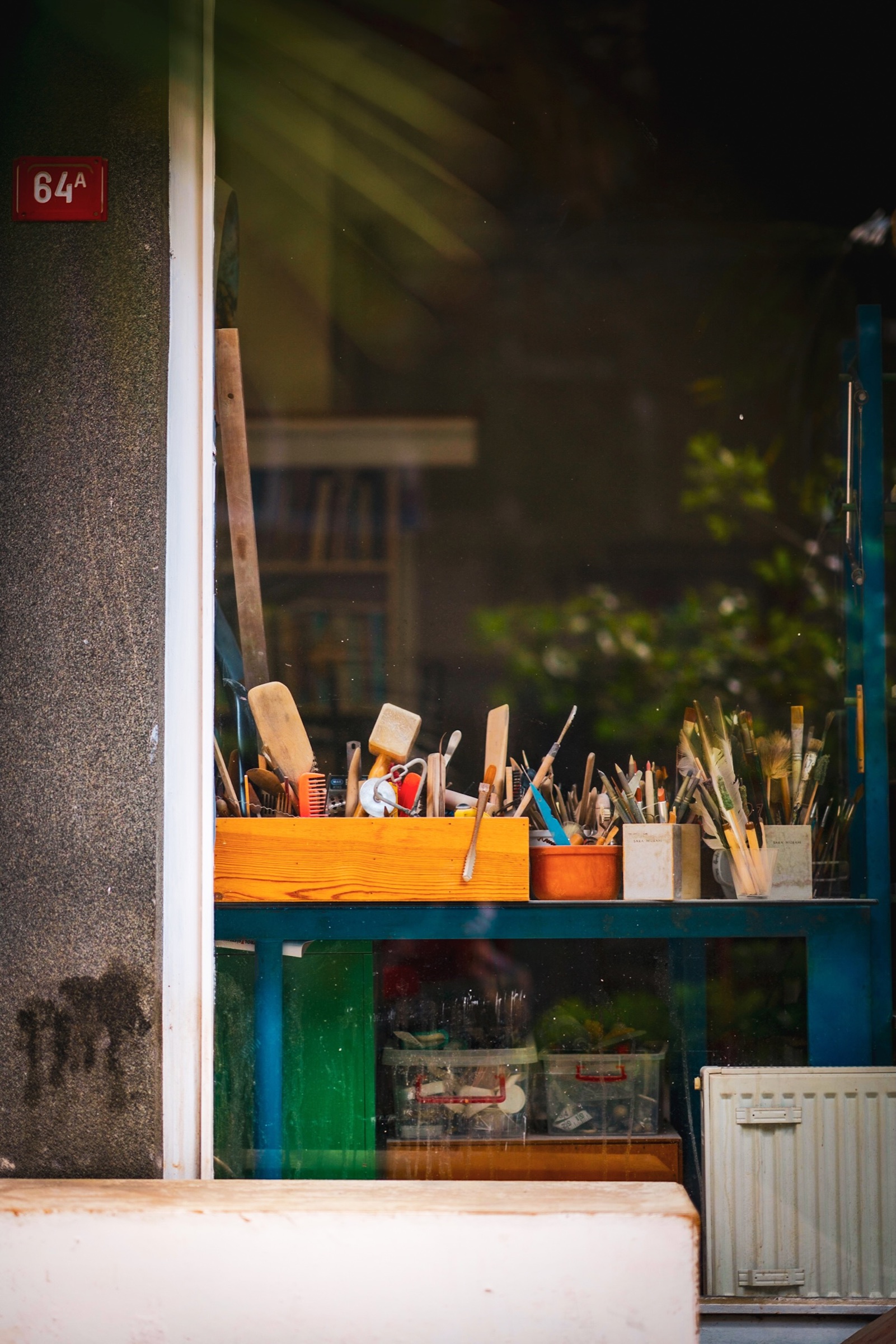 Sunlight falling across tools in an urban workshop window