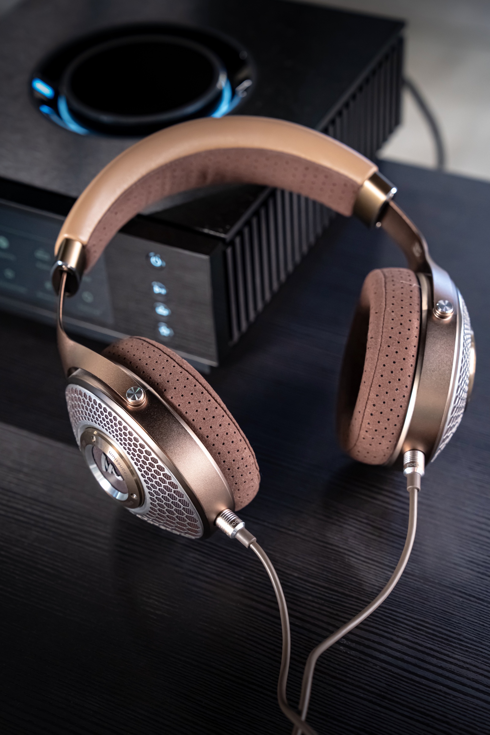 Full view of Focal Clear Mg headphones beside audio equipment