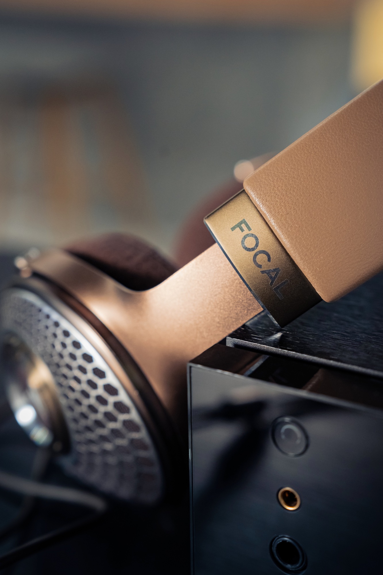 Focal lettering on a leather headband above the metal earcup
