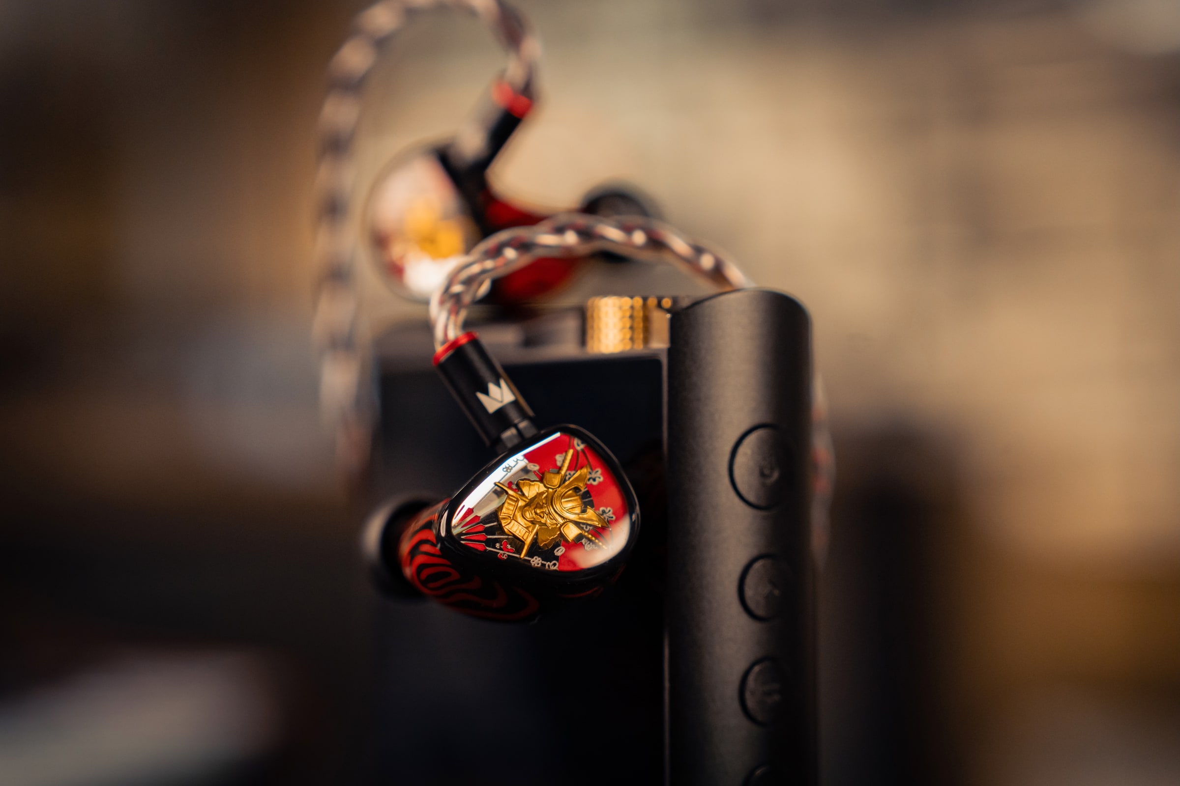 Noble Audio in-ear monitors arranged with a portable audio player