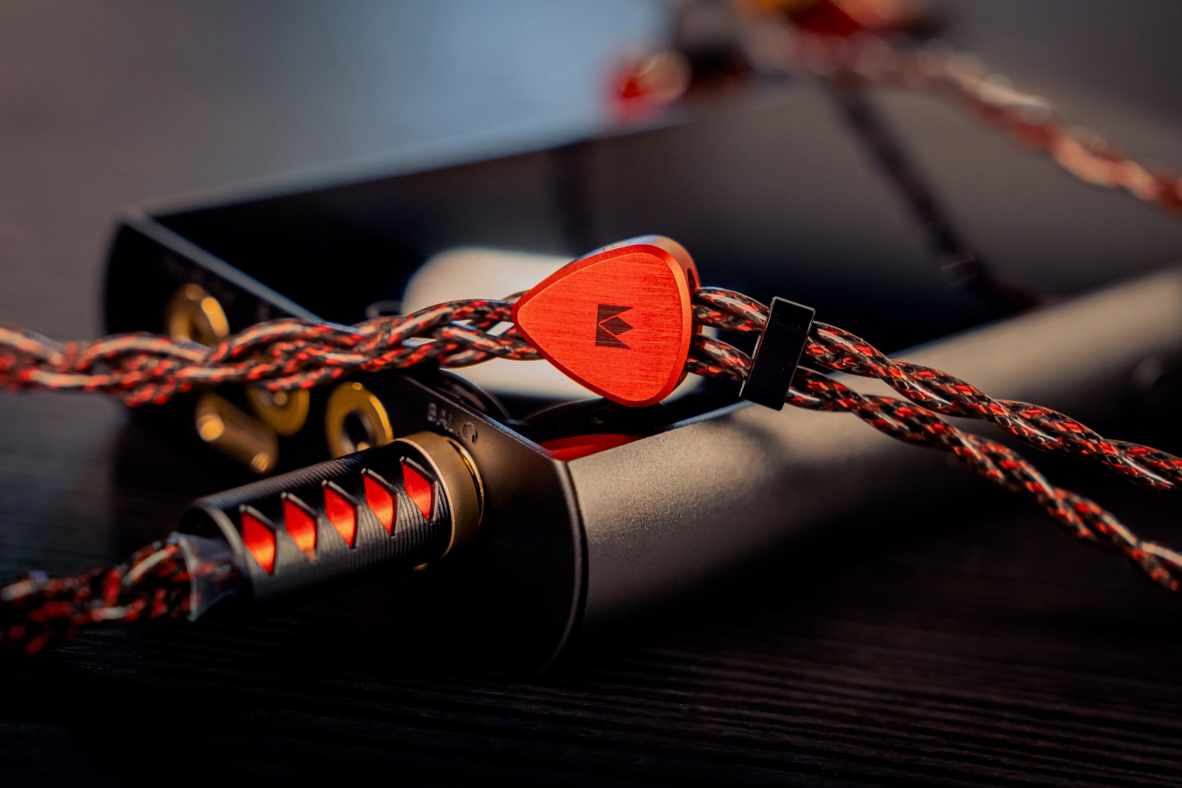 Noble Audio in-ear monitors photographed with braided cable and amplifier