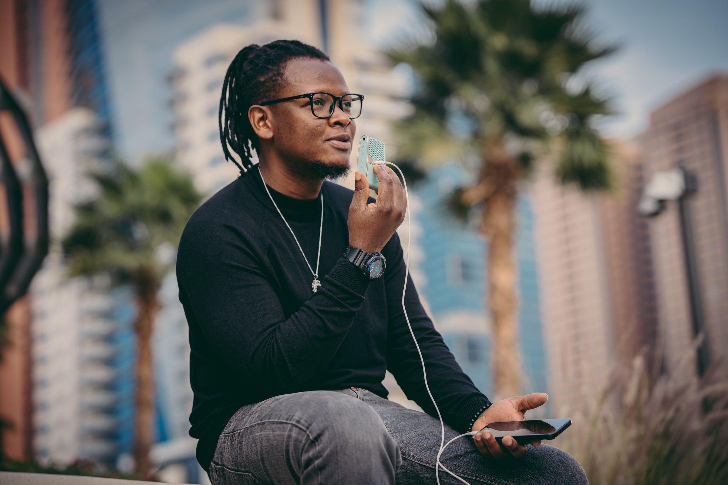Man using a compact Tula microphone outdoors