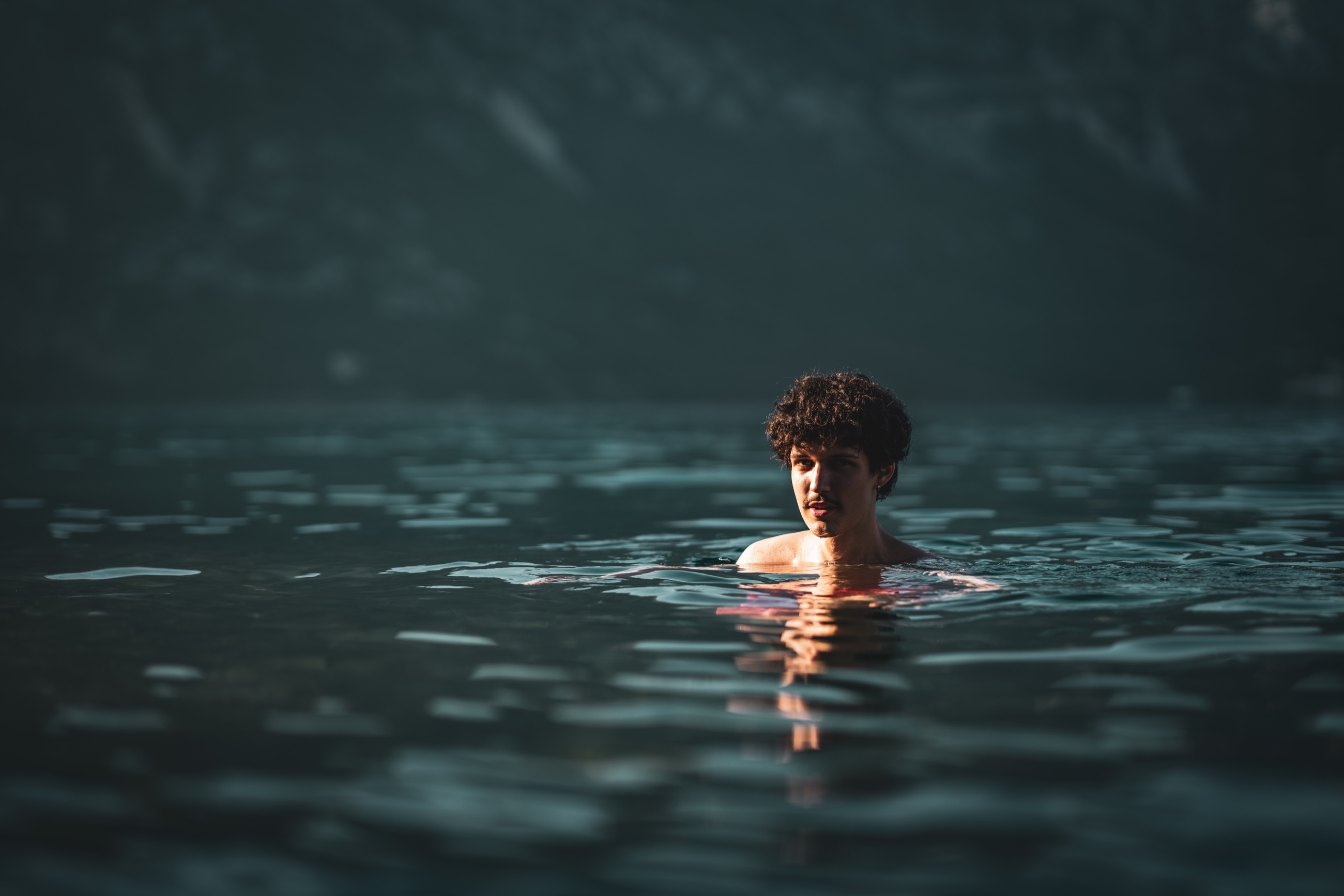 Cinematic portrait of a man standing in dark water